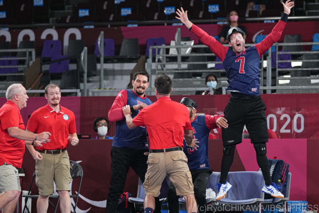 A player from the USA jumps high into the air to celebrate an overtime win against the Ukraine