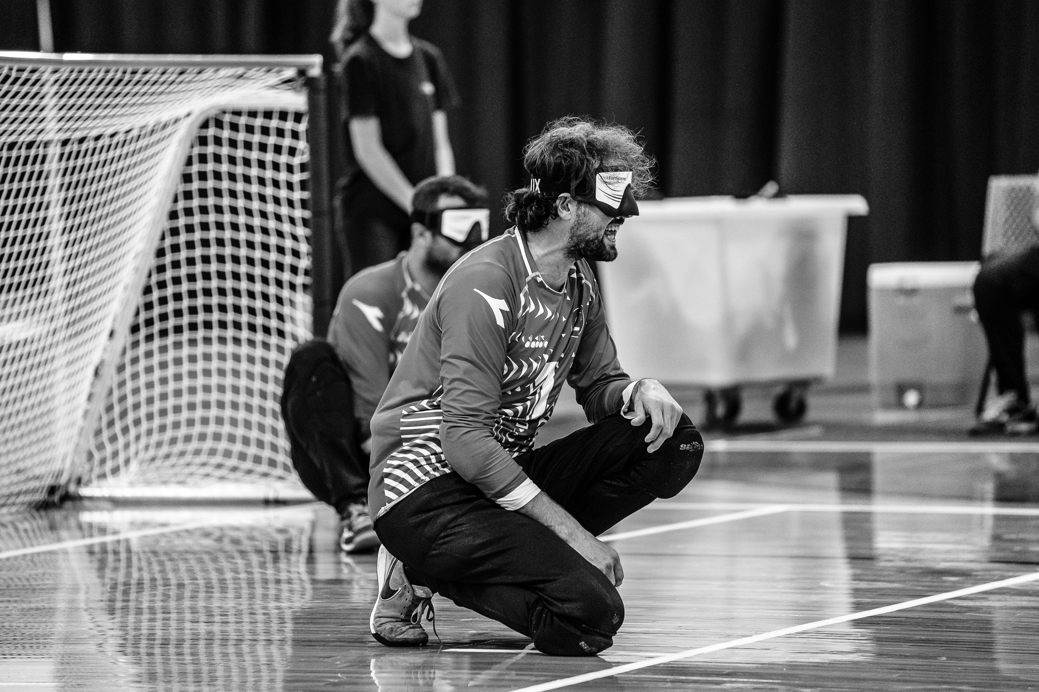 Huseyin Alkan of Turkey men's goalball team kneels on the court during a game