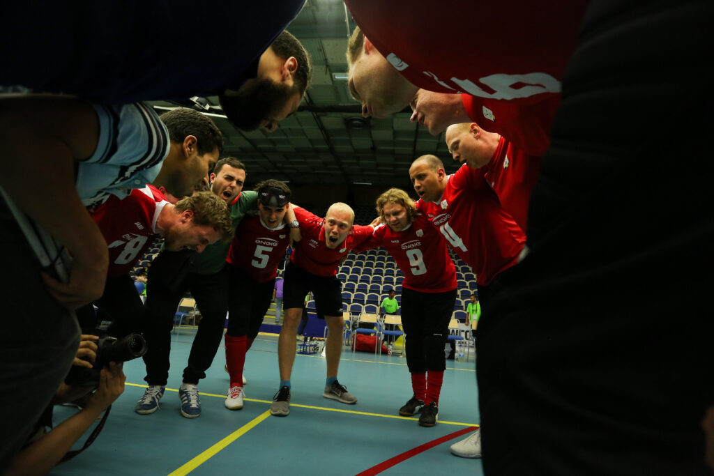 The Belgian men's goalball team gather together for a huddle