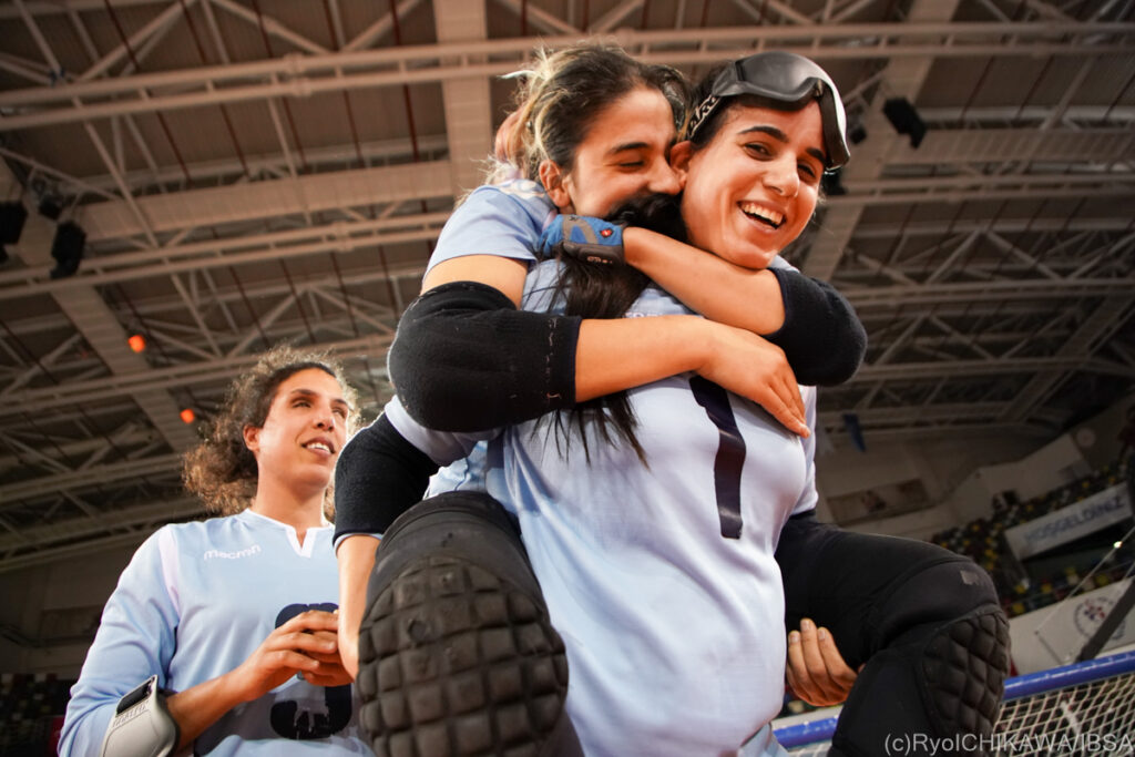 A player from Israel piggy-backs onto a teammate