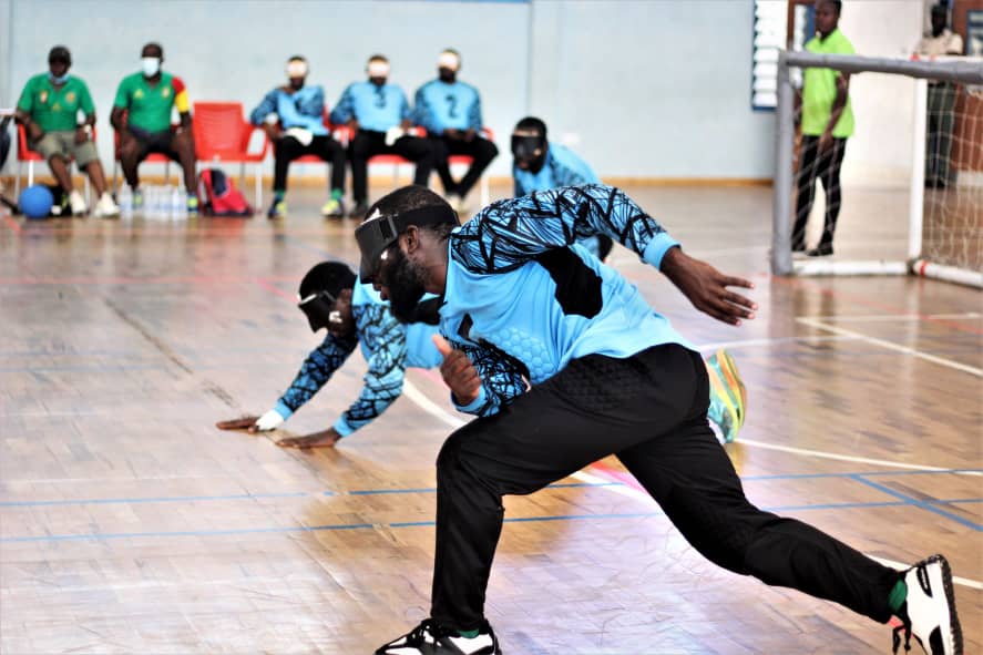 A male goalball player is pictured following a throw