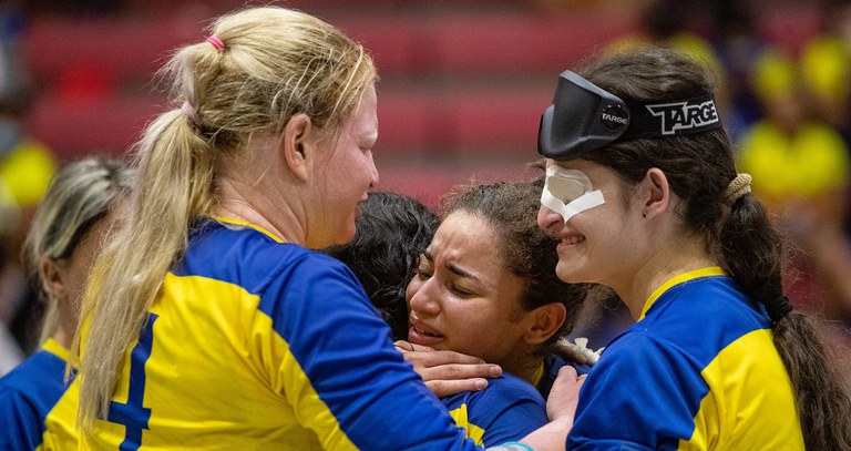 Players from the Brazilian women's team hug and celebrate after winning their semi-final