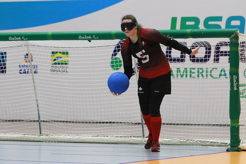 A female goalball player from Canada prepares to take a shot in front of goal